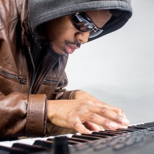 man with sunglasses playing keyboard